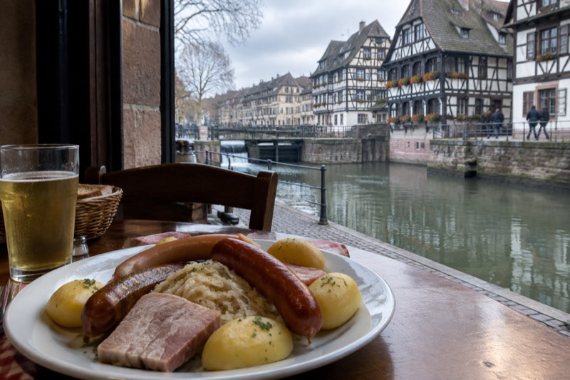 A plate of choucroute garnie with sausages, pork and boiled potatoes in a traditional Alsatian restaurant.