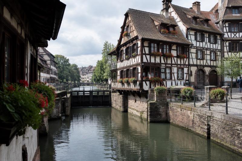 Timber-framed tanners' houses lean over a lock on the Ill, geraniums on the window sills.