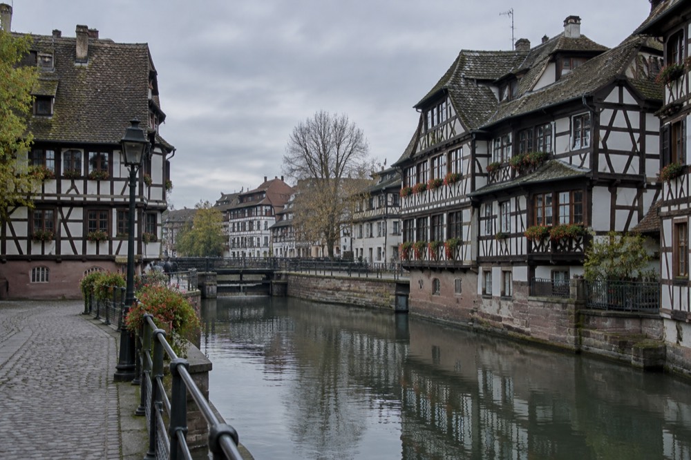 Half-timbered houses along a canal in Strasbourg's Petite France quarter on a quiet morning