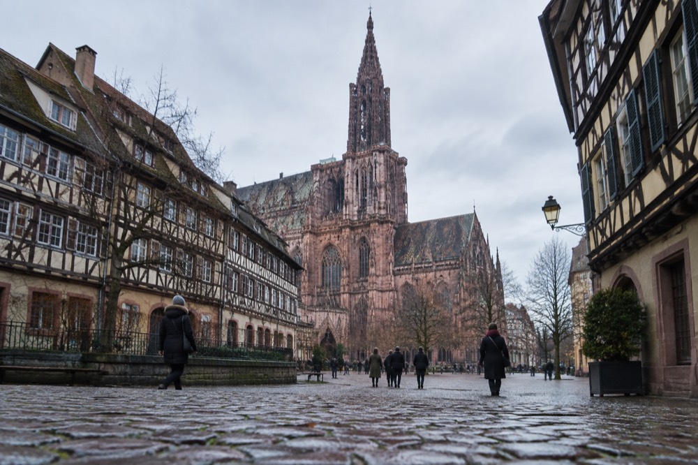 Half-timbered houses and a church spire above Strasbourg rooftops on a cold December afternoon