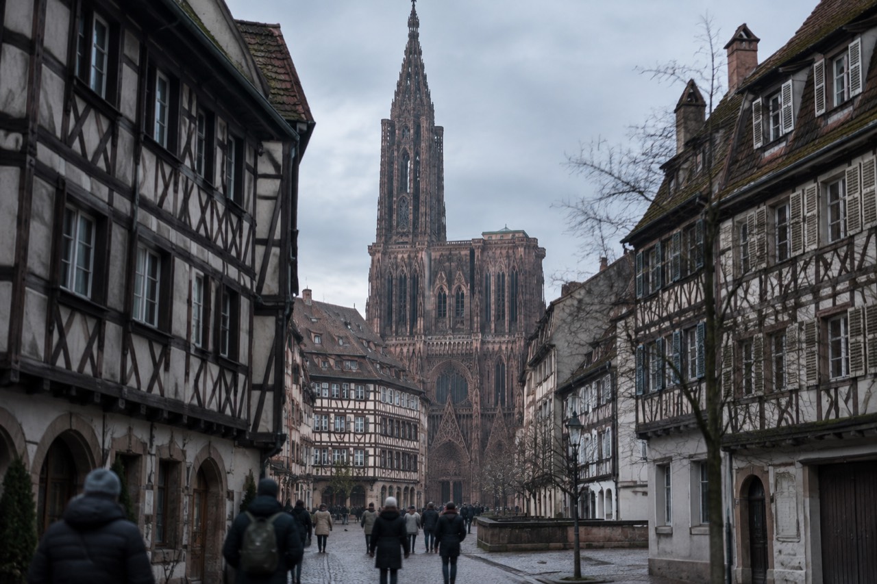 Half-timbered houses and a church spire above Strasbourg rooftops on a cold December afternoon