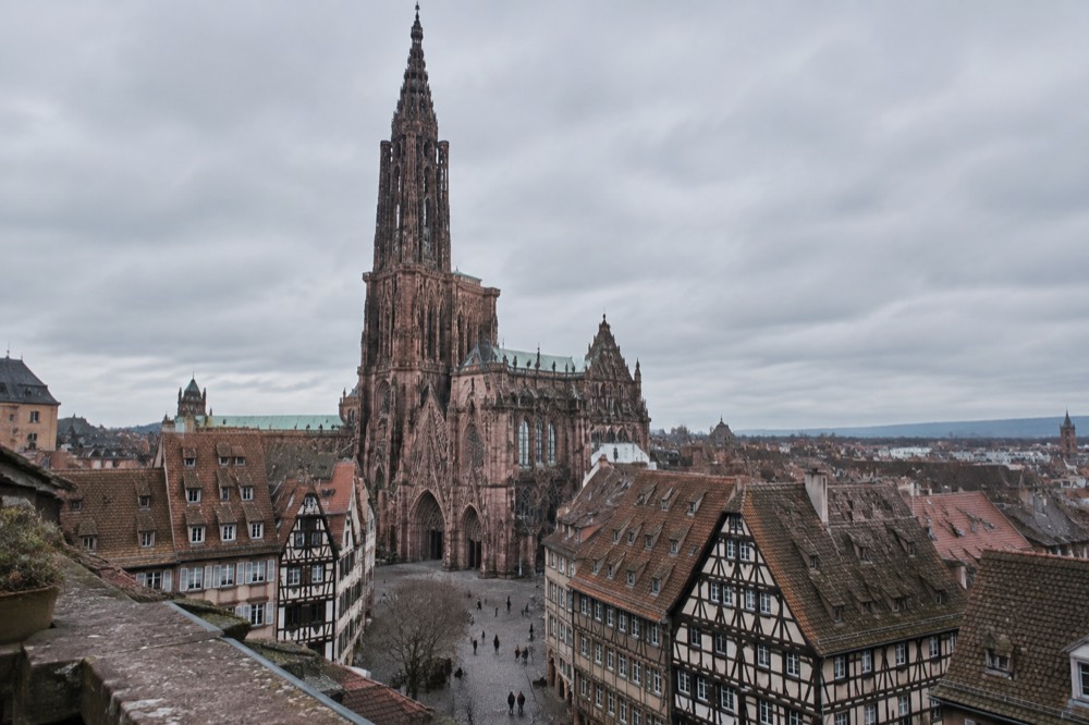 The cathedral spire rising above rooftops seen from a terrace viewpoint