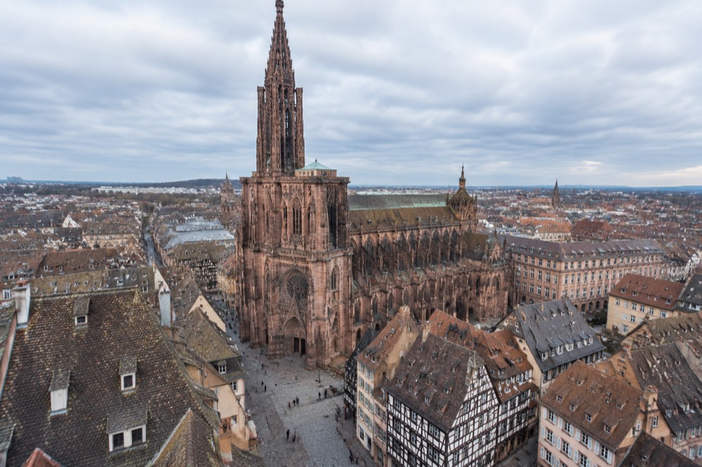 The single Gothic spire of Strasbourg Cathedral rising above the rooftops of the old town