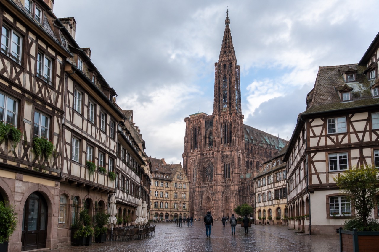 The single Gothic spire of Strasbourg Cathedral rising above the rooftops of the old town