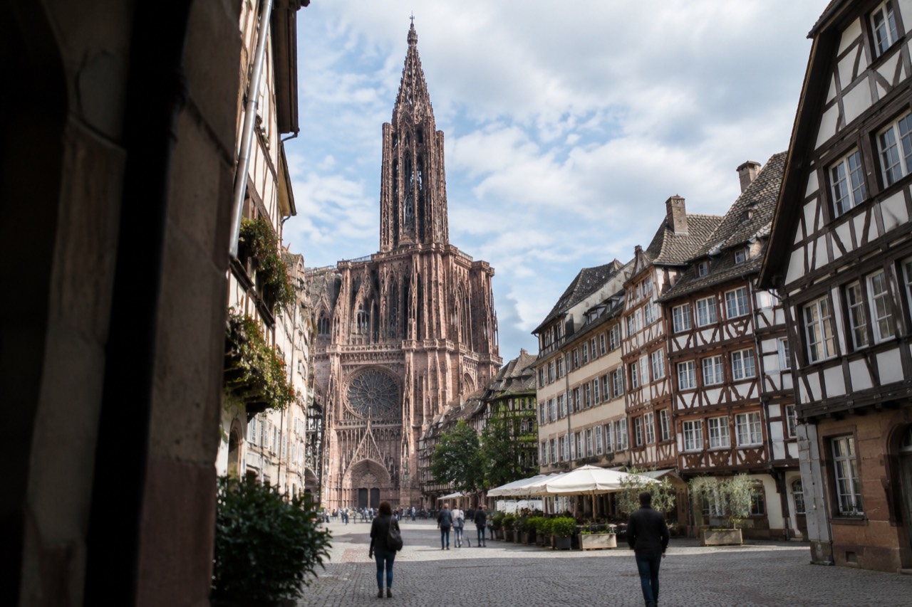 The single spire and west front of Strasbourg Cathedral rising above the old city rooftops
