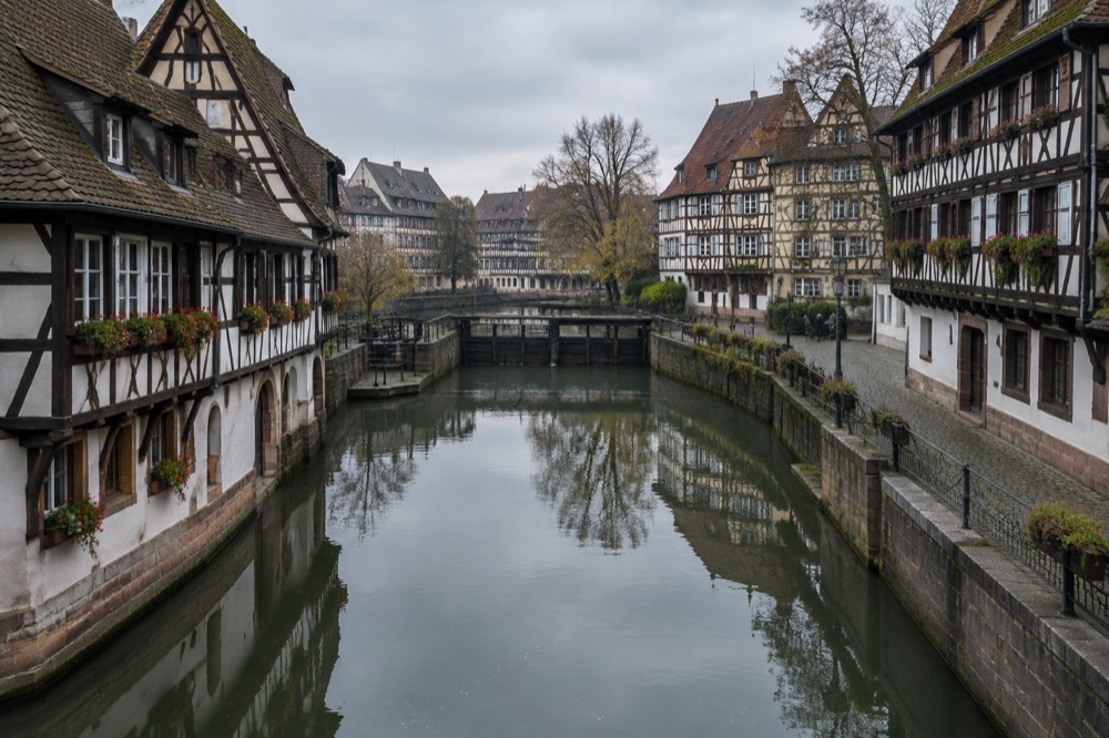 Half-timbered houses reflected in a calm canal in Petite France, Strasbourg
