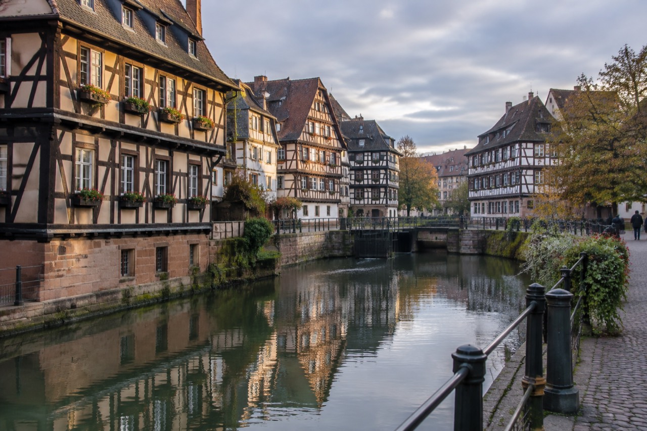 Half-timbered houses reflected in a calm canal in Petite France, Strasbourg