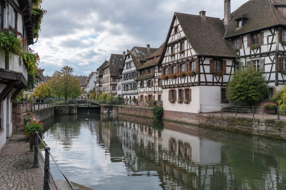 Half-timbered houses reflected in the water of a canal in Petite France, Strasbourg