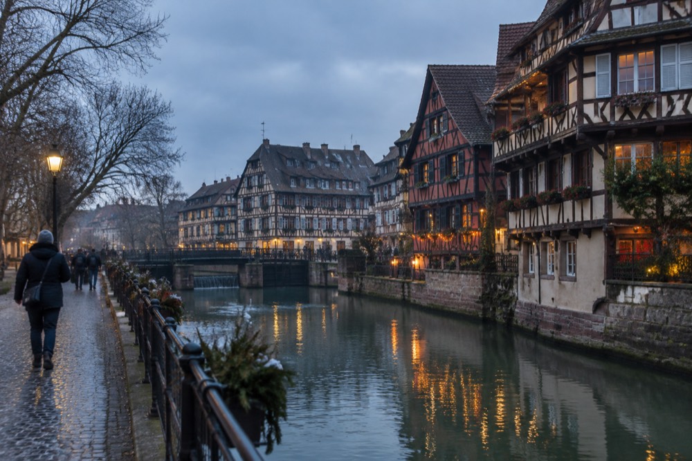 Decorated half-timbered buildings along the River Ill in Petite France at night