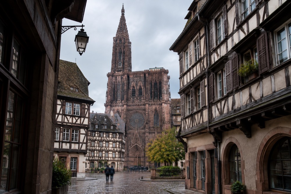 Gothic cathedral facade rising above rooftops in Strasbourg, France