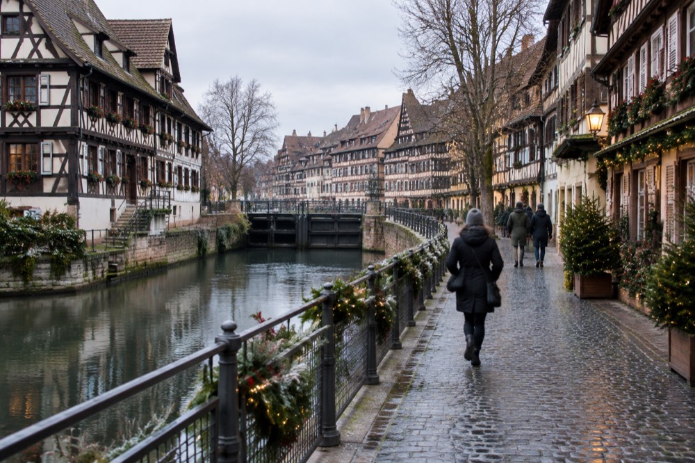 Half-timbered buildings and a decorated lane in Petite France lit for the Christmas season