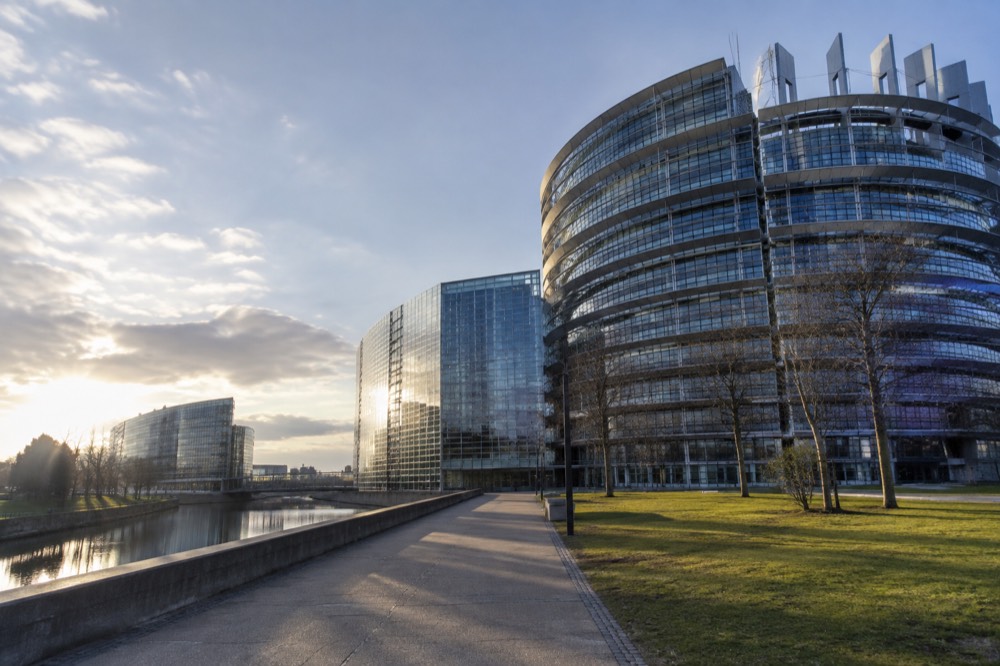 Morning light on the glass towers of the European district with empty walkways