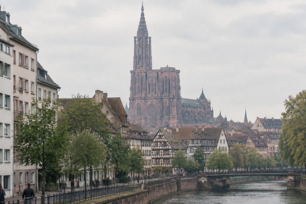 Contrast of modern European district buildings with distant historic rooftops of Strasbourg
