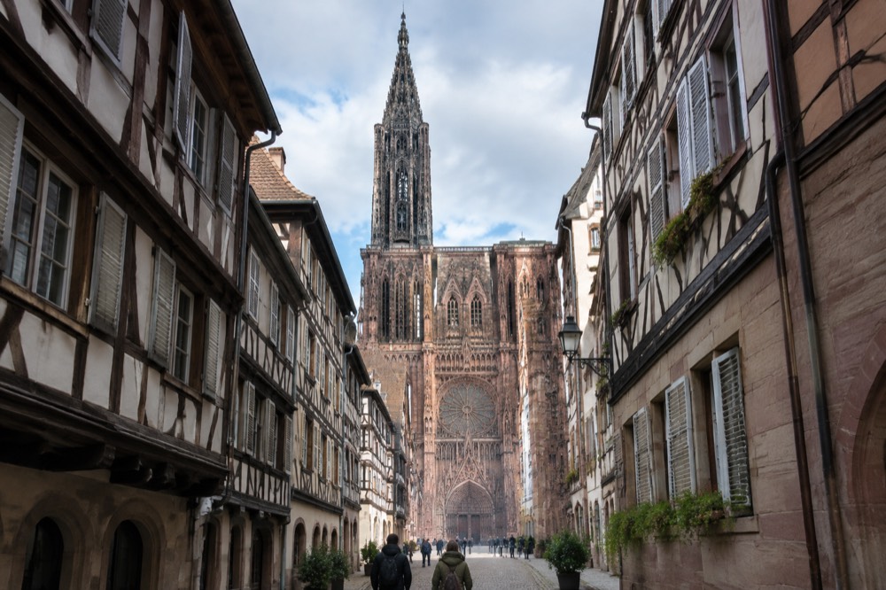 The west front of Strasbourg Cathedral seen from a narrow Old Town street