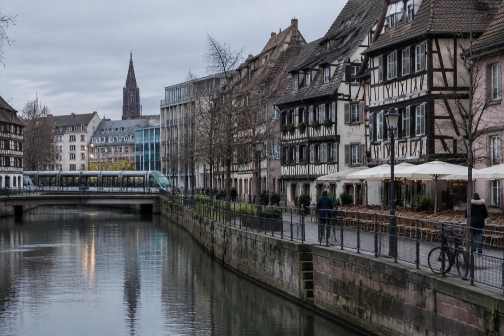 A Strasbourg tram passing modern buildings near the edge of the Krutenau