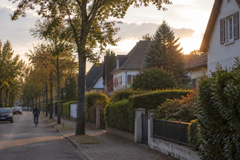 Villas with gardens behind hedges on a calm street in Robertsau, Strasbourg