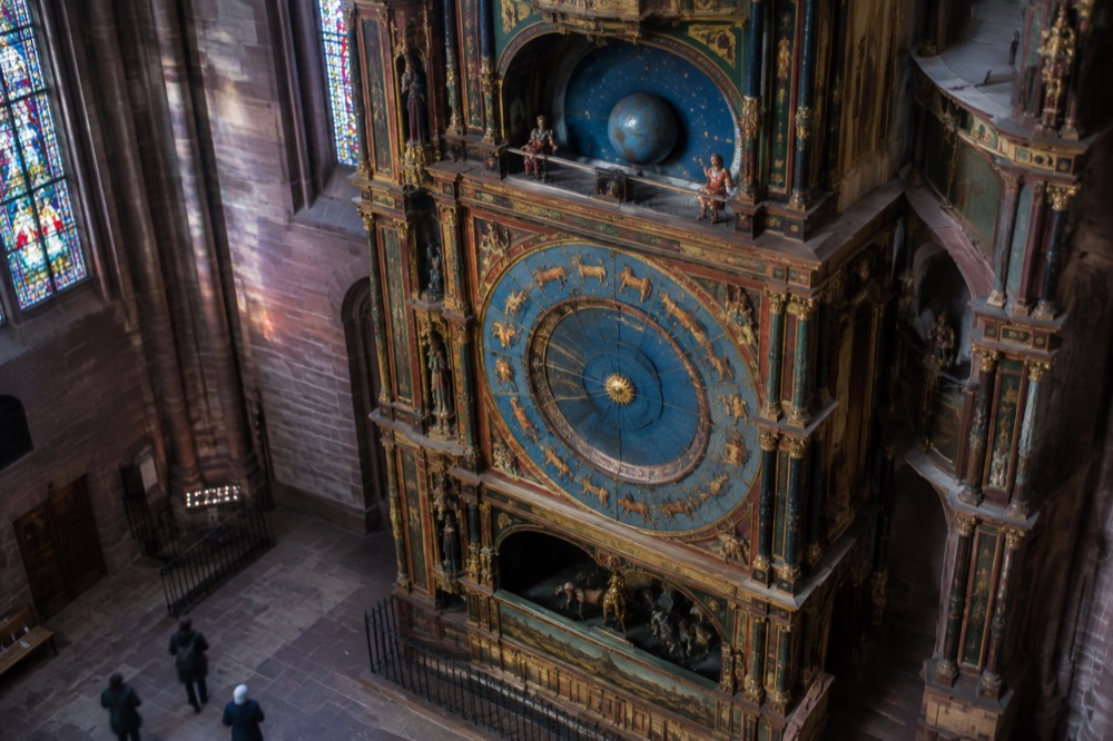 One of the clock's painted calendar dials showing zodiac and month rings in gold and blue