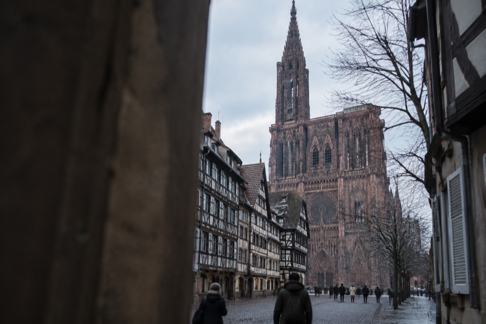 The cathedral's west facade above the rooftops of Strasbourg under a winter sky