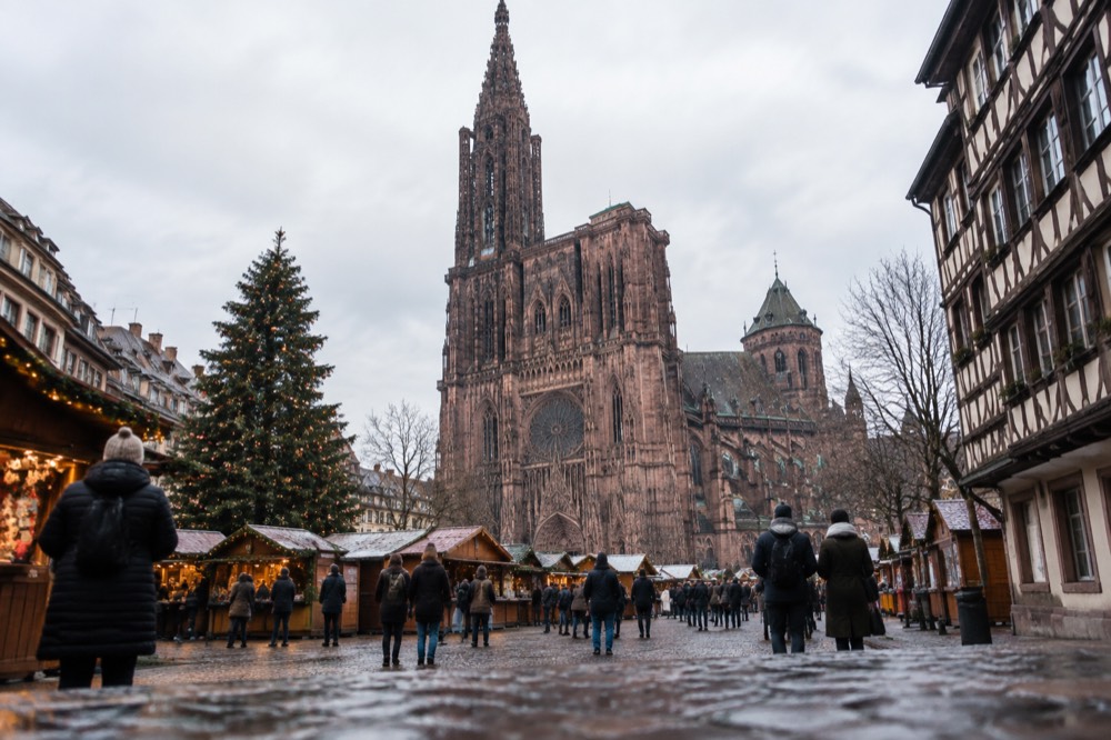 Christmas market chalets and a decorated tree in a Strasbourg square