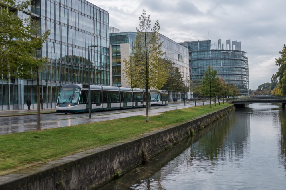 A Strasbourg tram passing modern buildings in the European Quarter