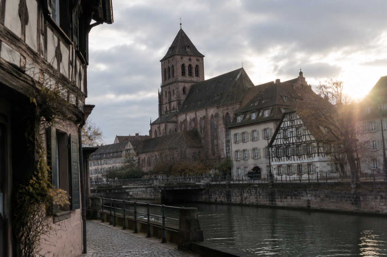 The stone tower and roofline of the Église Saint-Pierre-Le-Jeune rising above the rooftops of central Strasbourg