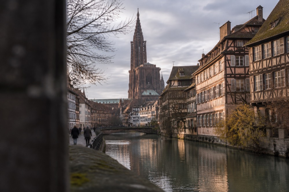 Half-timbered houses and a canal in a riverside quarter of Strasbourg at golden hour