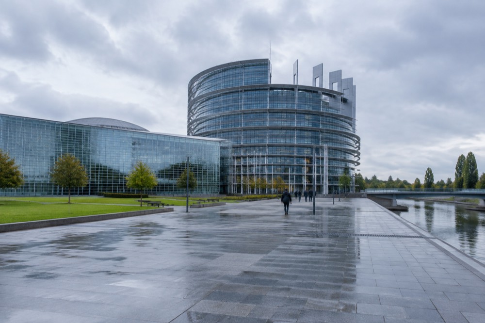 The modern facade of the European Parliament in Strasbourg seen from across a wide plaza