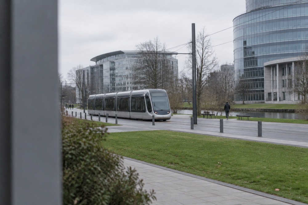 A tram passing modern buildings on a wide boulevard in the European Quarter of Strasbourg