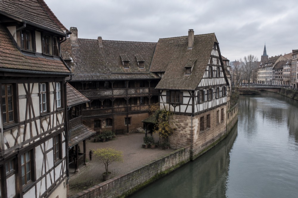 Half-timbered museum buildings beside a quiet canal in Strasbourg's historic centre