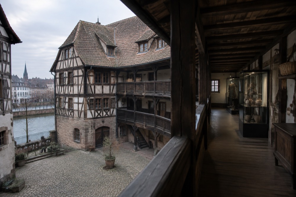 Gallery interior with timber ceiling and display cases of regional objects