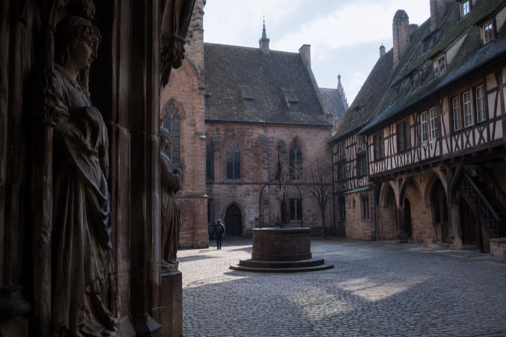 Gothic stone sculpture displayed in a gallery with vaulted ceilings