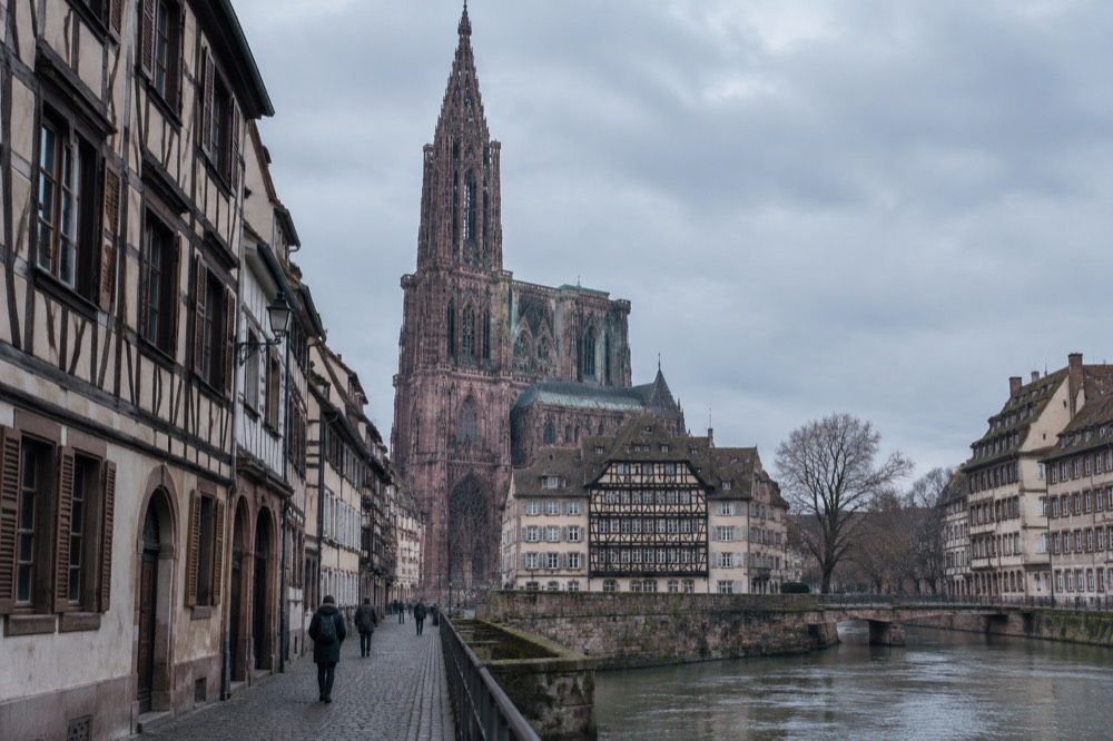 Historic museum hall in Strasbourg with display cases and stone vaulting