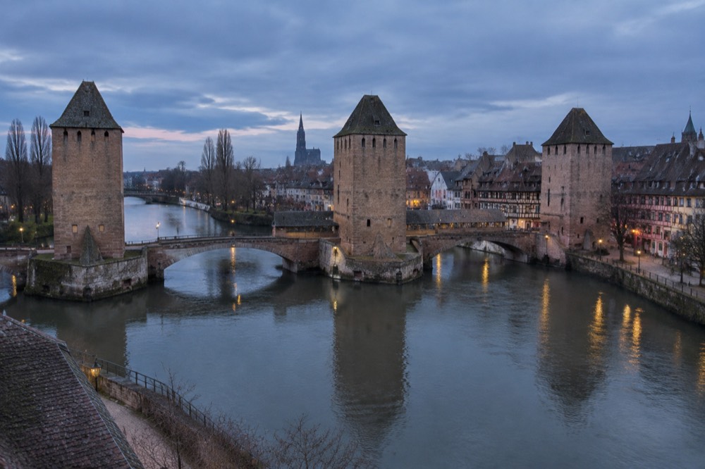 The stone towers and covered bridge spans of the Ponts Couverts over the River Ill in Strasbourg