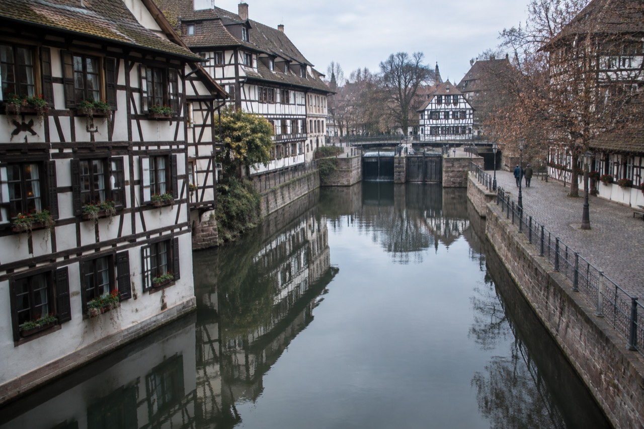 Half-timbered houses reflected in a calm canal in Petite France, Strasbourg