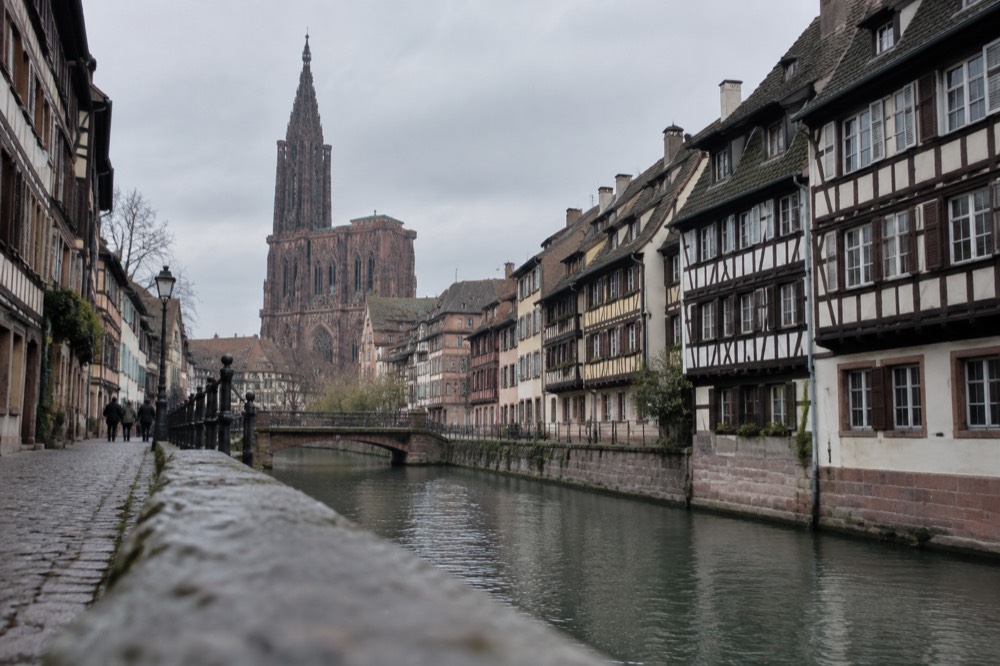 A narrow street of half-timbered houses beside a canal in Strasbourg