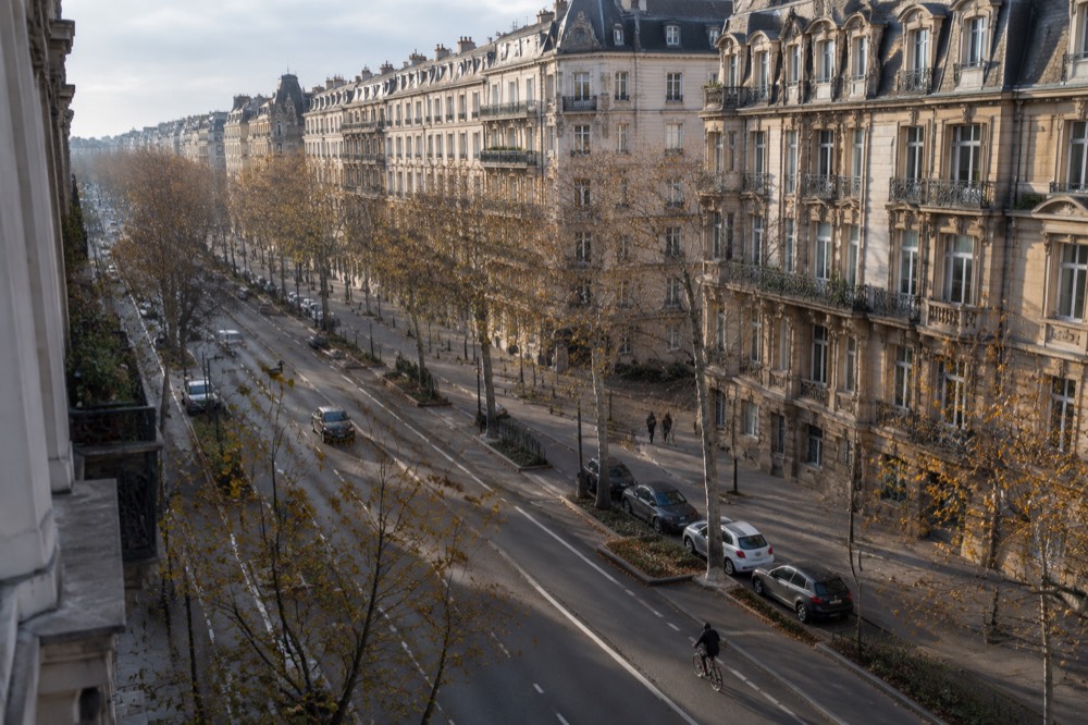 A wide avenue of grand apartment facades in the Neustadt district under a clear sky