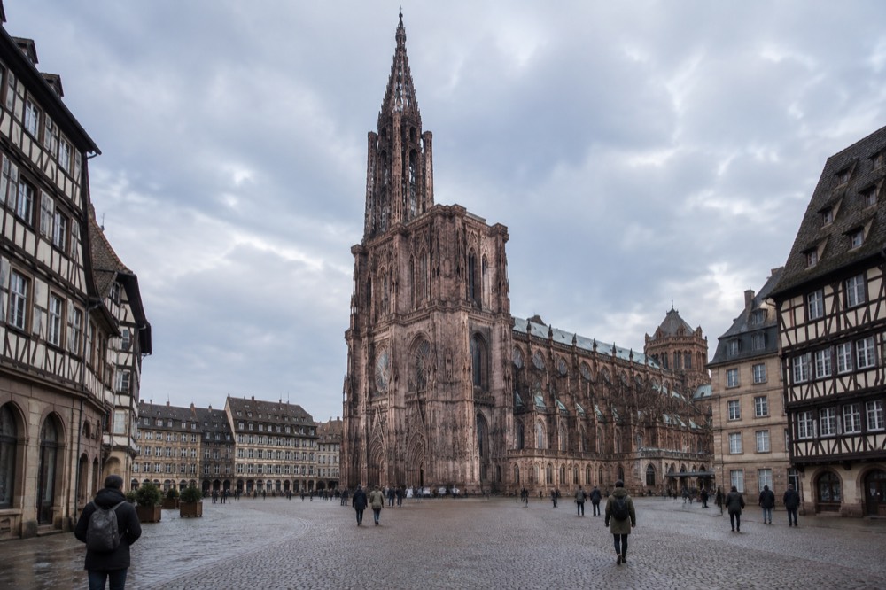 A broad open square in central Strasbourg with historic buildings on all sides