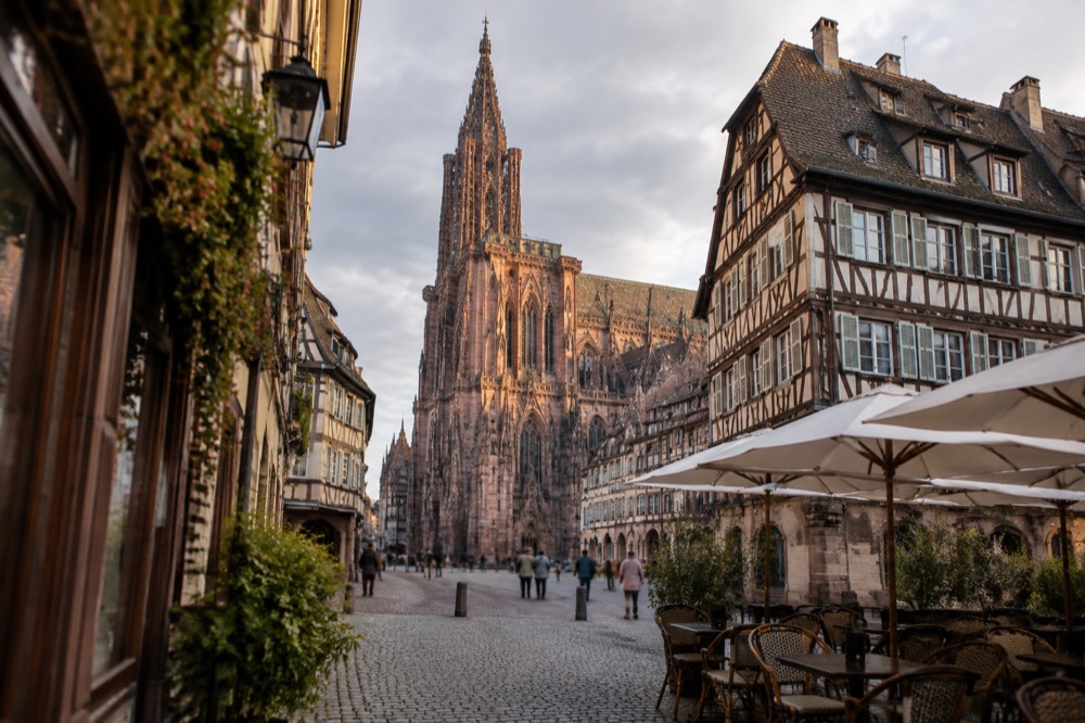 Historic building facades and café terraces around a square in Strasbourg old town