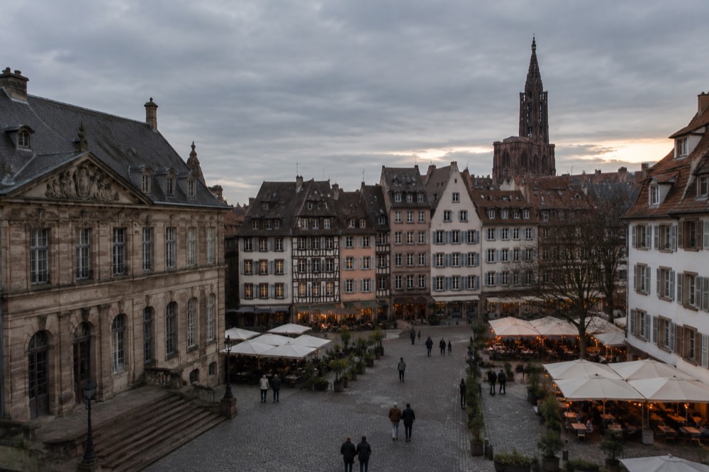 Evening light over rooftops and a church spire seen from central Strasbourg
