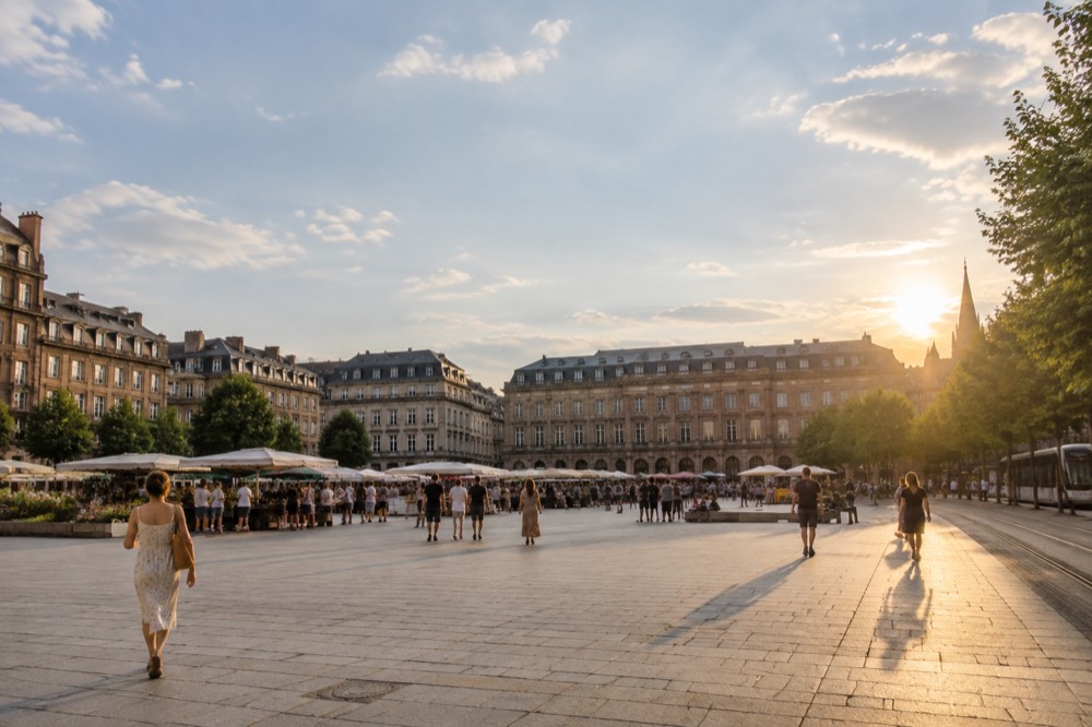 Place Kleber in summer with market stalls and people enjoying the open space, the Aubette building in the background