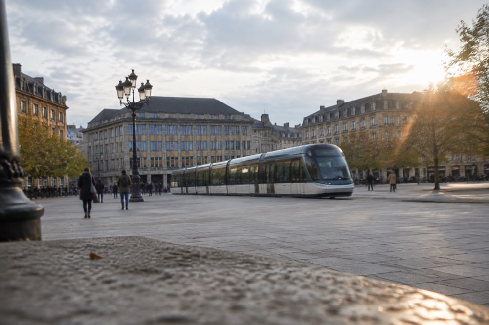 A tram passing through Place Kleber with the Aubette building in the background, showing the integration of public transport into the square