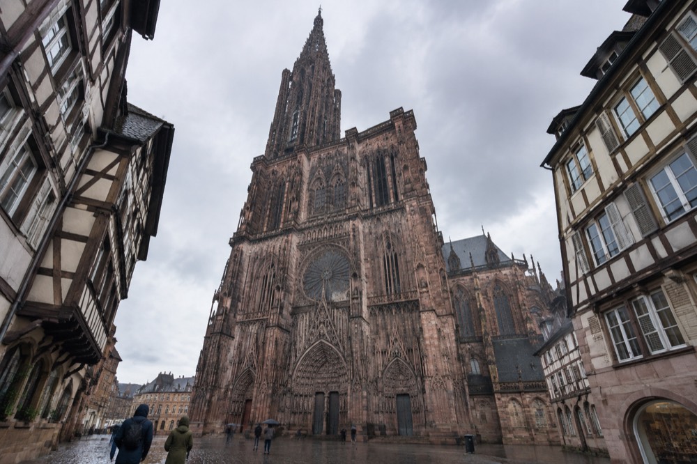 Gothic cathedral facade with a single spire above a historic square in Strasbourg