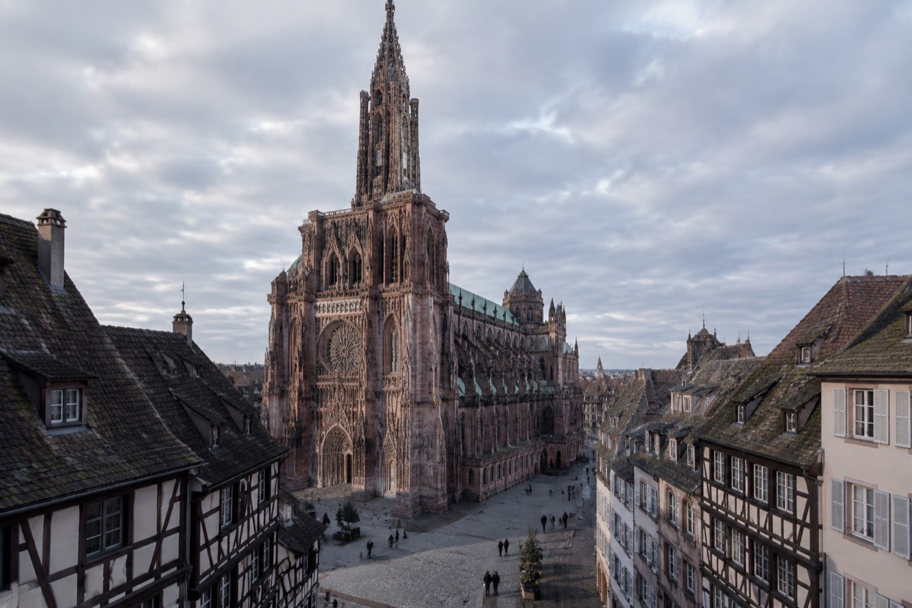 Gothic cathedral facade with a single spire above a historic square in Strasbourg