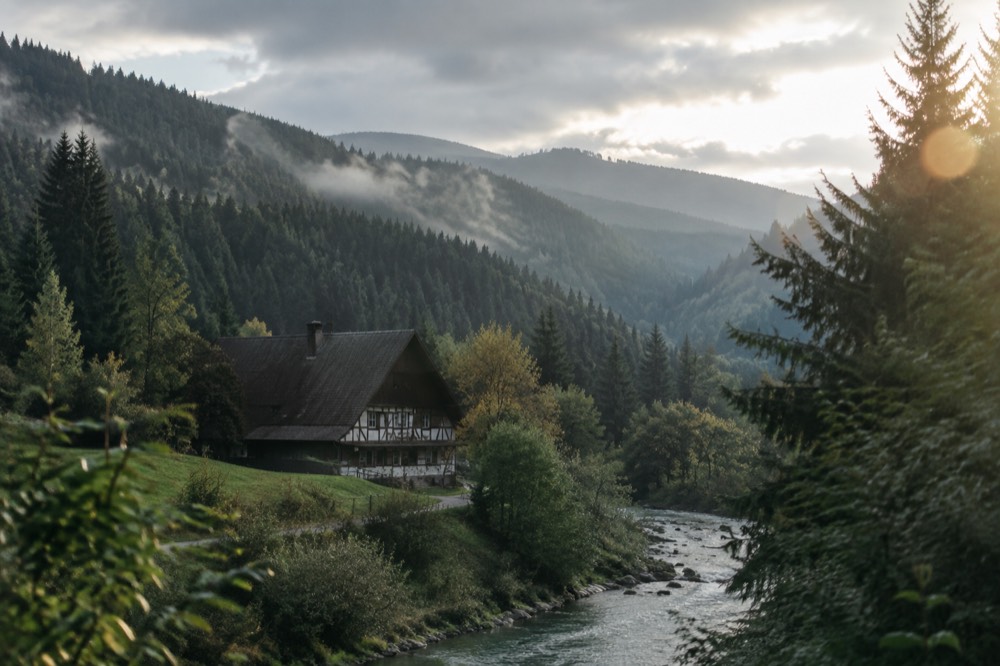 Dense Black Forest hillsides with dark conifer slopes under drifting cloud