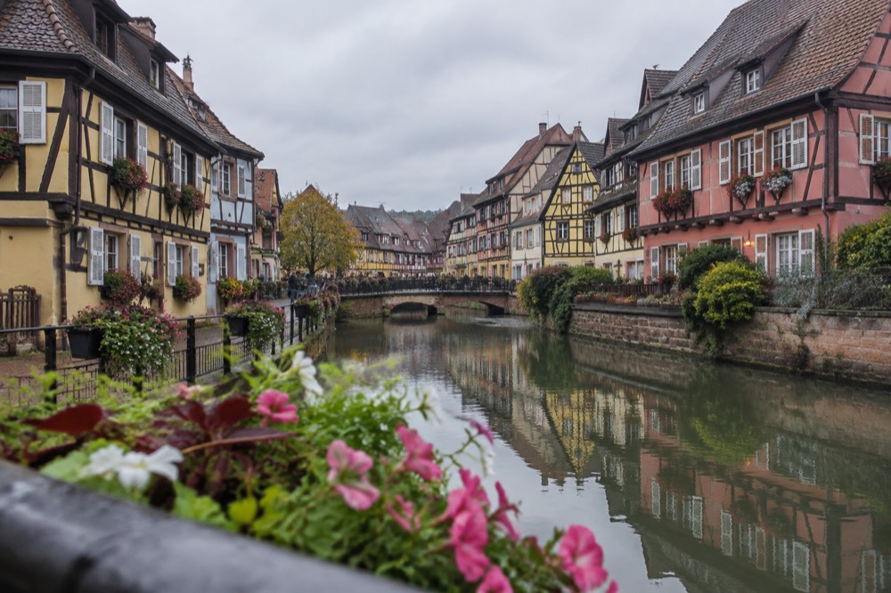 Evening light on a Colmar canal with reflections of half-timbered facades