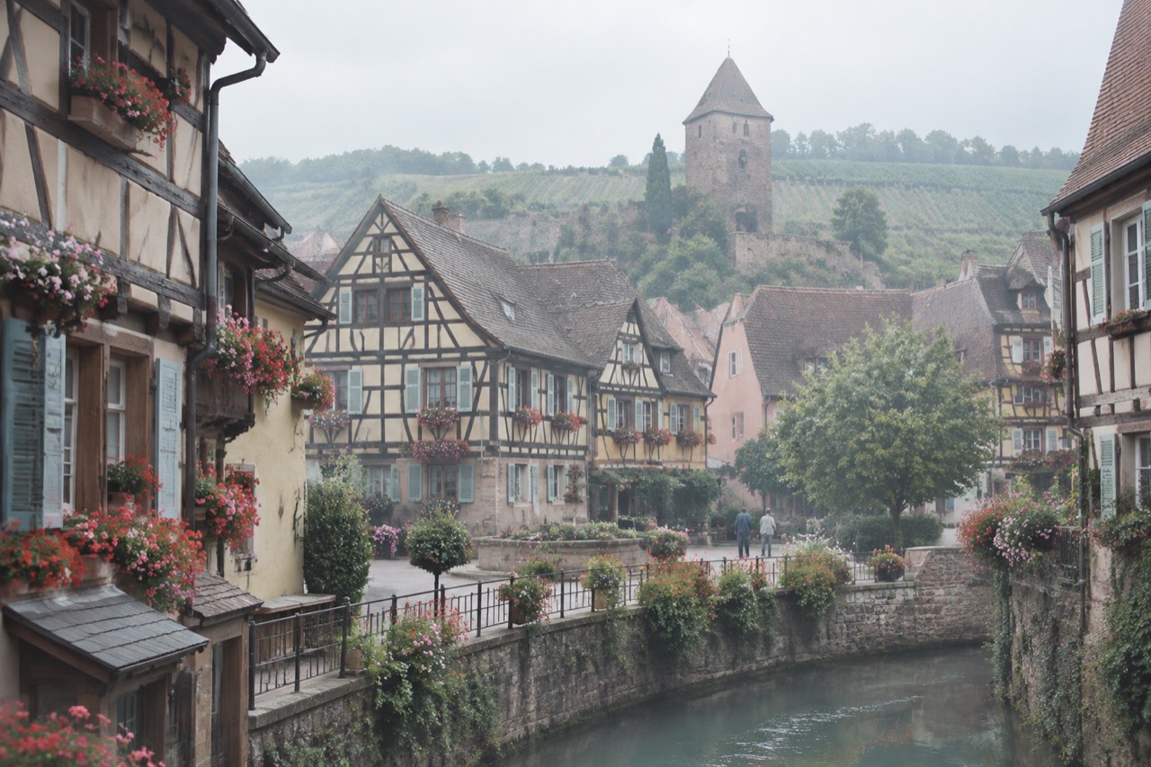 Half-timbered Alsatian houses with flower boxes around a small village square in Eguisheim