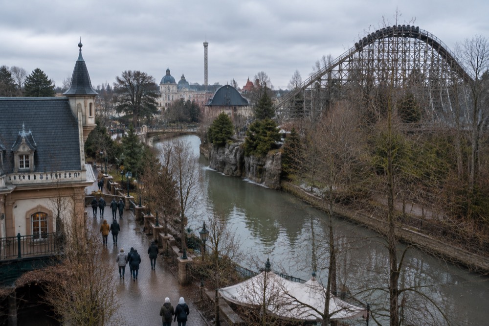 Wooden coaster structure framed by winter-bare trees