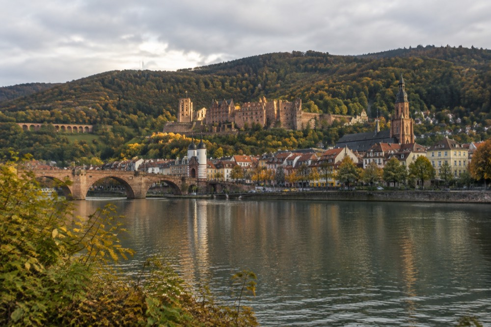 Heidelberg old town and castle ruins seen from the far bank of the River Neckar