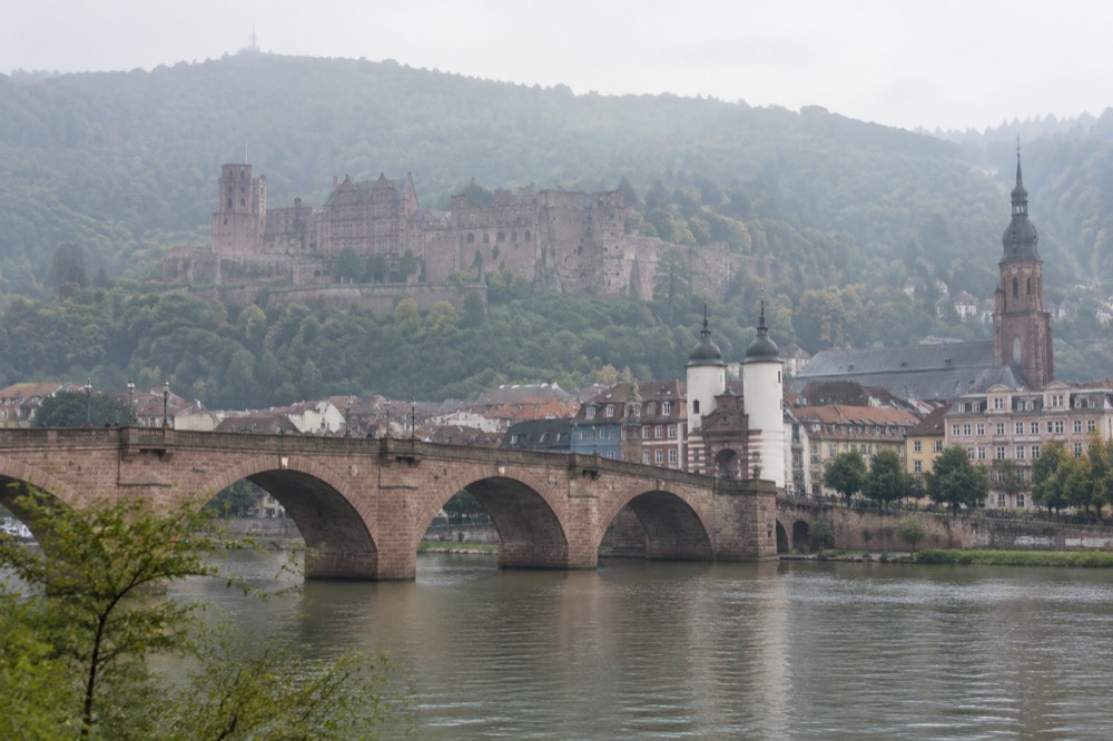 Stone bridge over the River Neckar with old town rooftops behind it