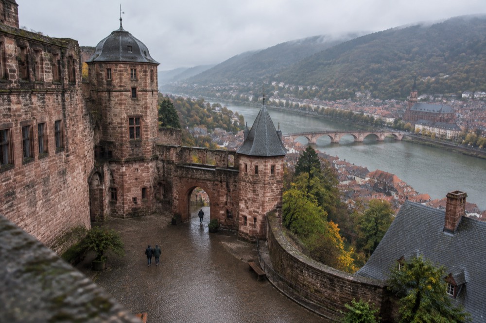 Courtyard of a stone castle with towers and an arched gateway